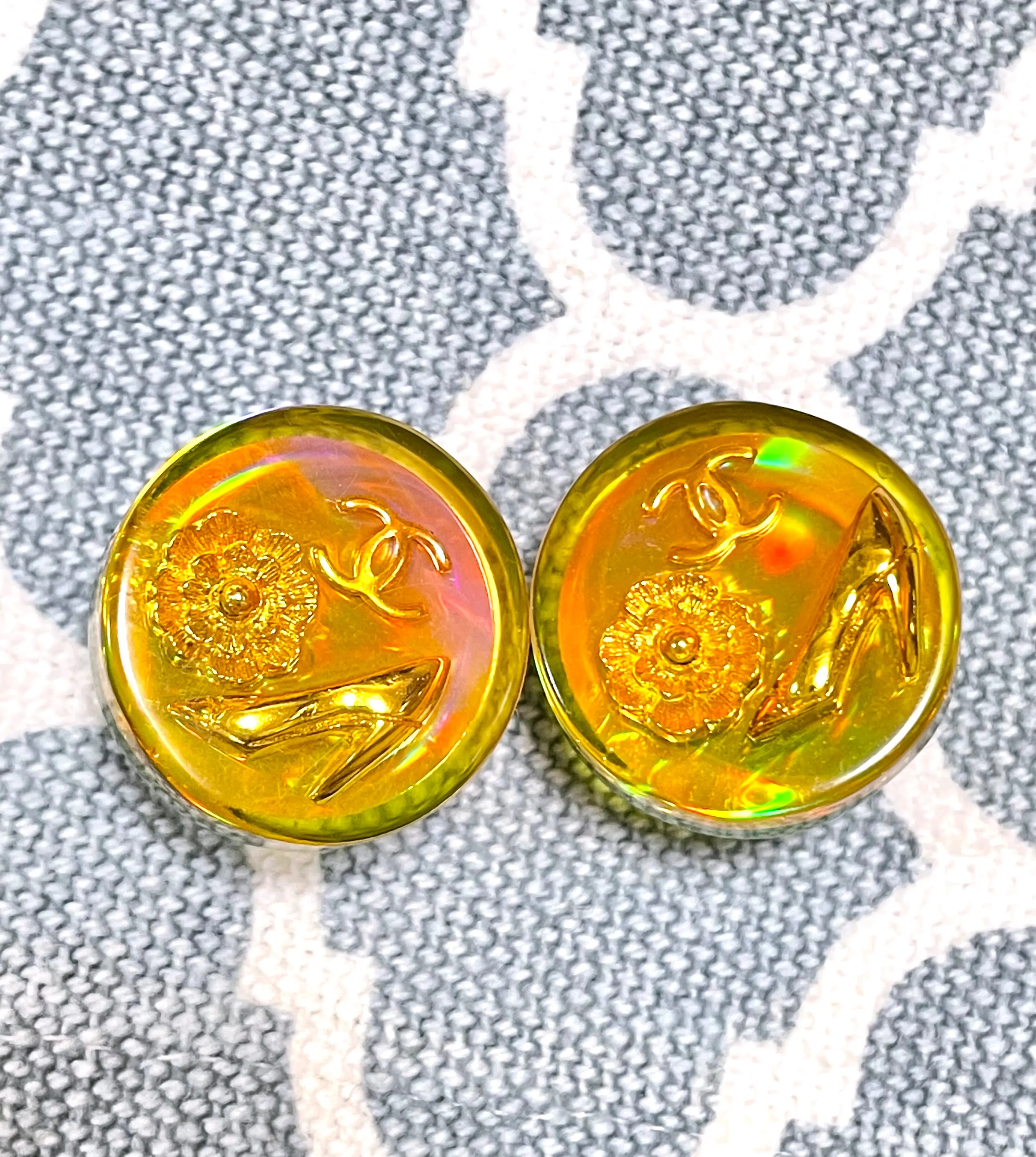 Vintage CHANEL yellow orange tone aurora resin earrings with Chanel iconic charms. Golden shoe, camellia, and CC mark in it. 041228an1